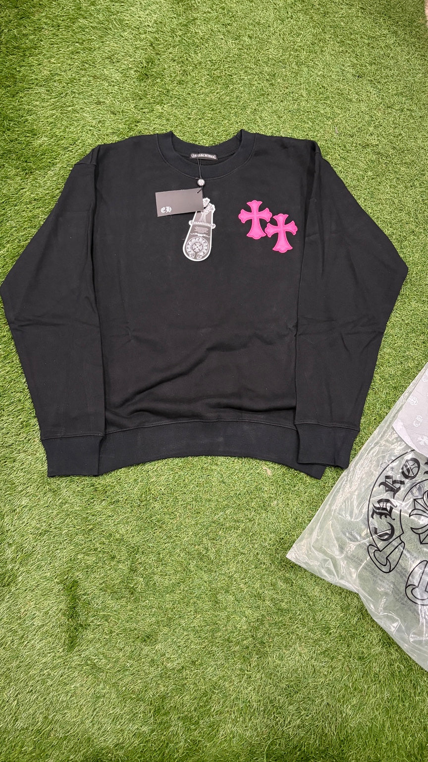 Black crewneck front with two pink cross appliques