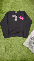 Black crewneck front with two pink cross appliques