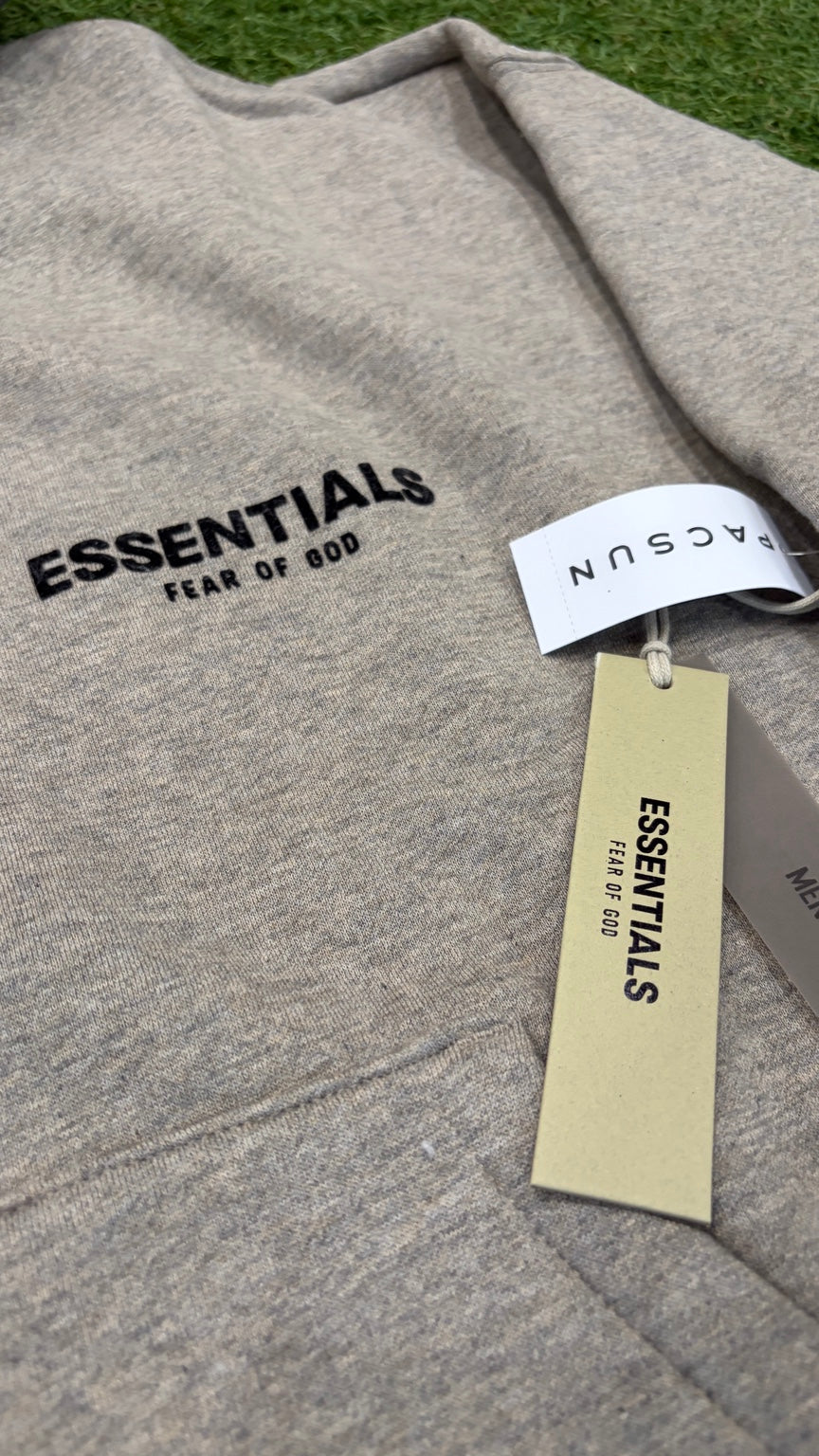 Dark Oatmeal Essentials hoodie front logo detail