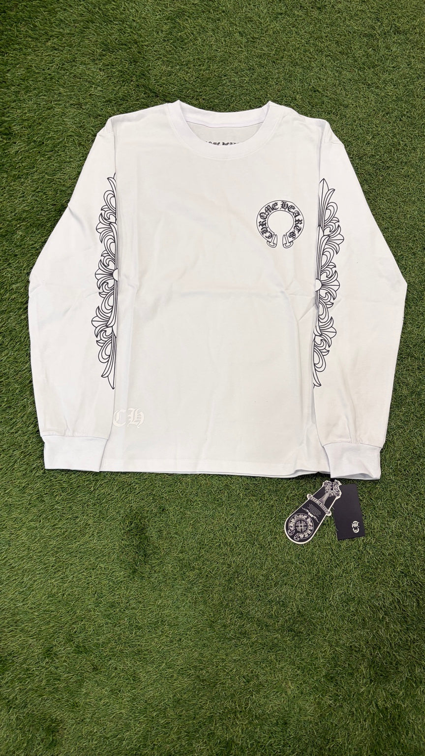 White long sleeve with black horseshoe chest graphic and black ornamental sleeves, full front