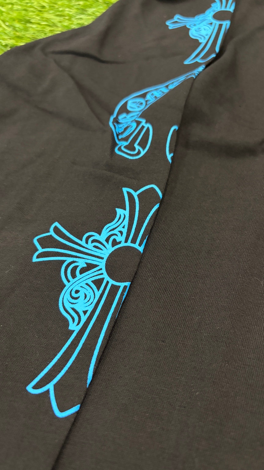 Blue sleeve cross and horseshoe design close-up