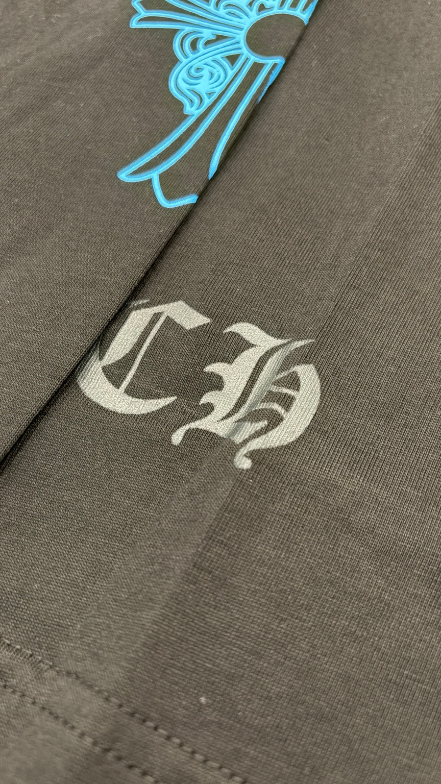 CH lettering detail near front hem