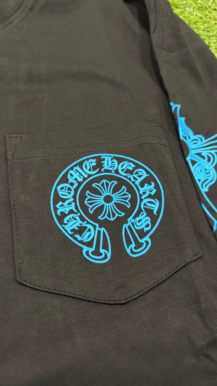 Close-up of blue horseshoe graphic on chest pocket